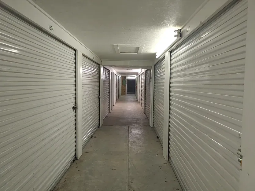 Indoor hallway with bright lighting and unit doors at Town and Country Self Storage_.webp